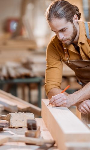 carpenter-working-with-a-wood-in-the-workshop-1.jpg